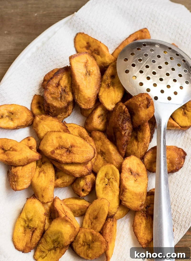 Crispy Sweet Fried Plantains (Tostones Maduros Recipe) 2 Sweet fried plantains placed on paper towel.