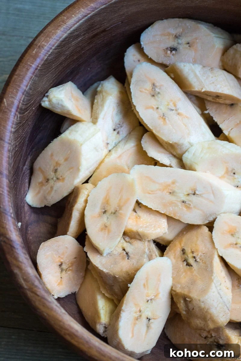 Crispy Sweet Fried Plantains (Tostones Maduros Recipe) 4 Slices of sweet plantains in a wooden bowl.