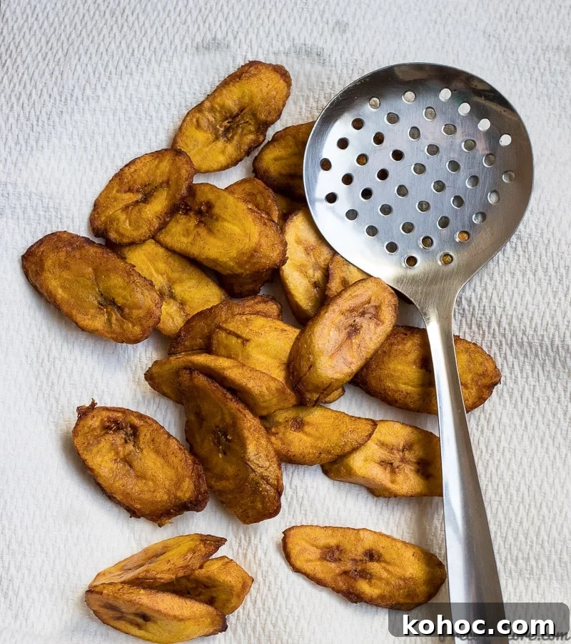 Crispy Sweet Fried Plantains (Tostones Maduros Recipe) 5 Golden brown sweet fried plantains on paper towels.