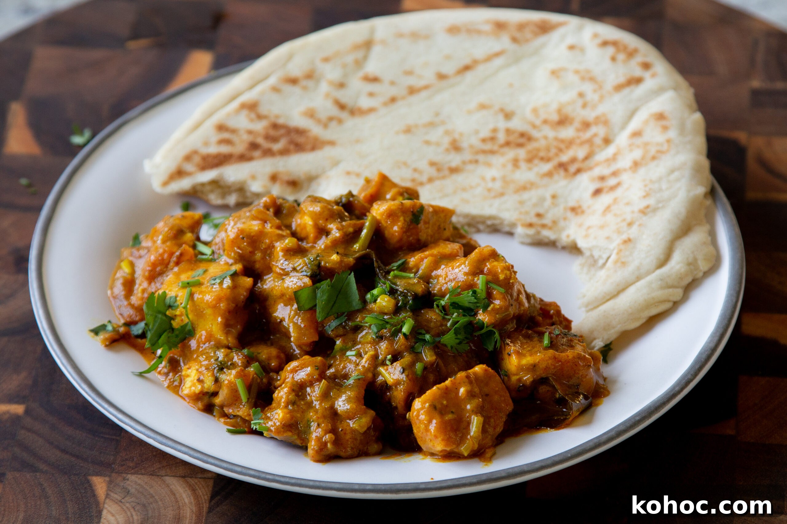 South Indian Black Pepper Tofu Curry with Caramelized Onions 3 tofu pepper fry on a plate with flatbread