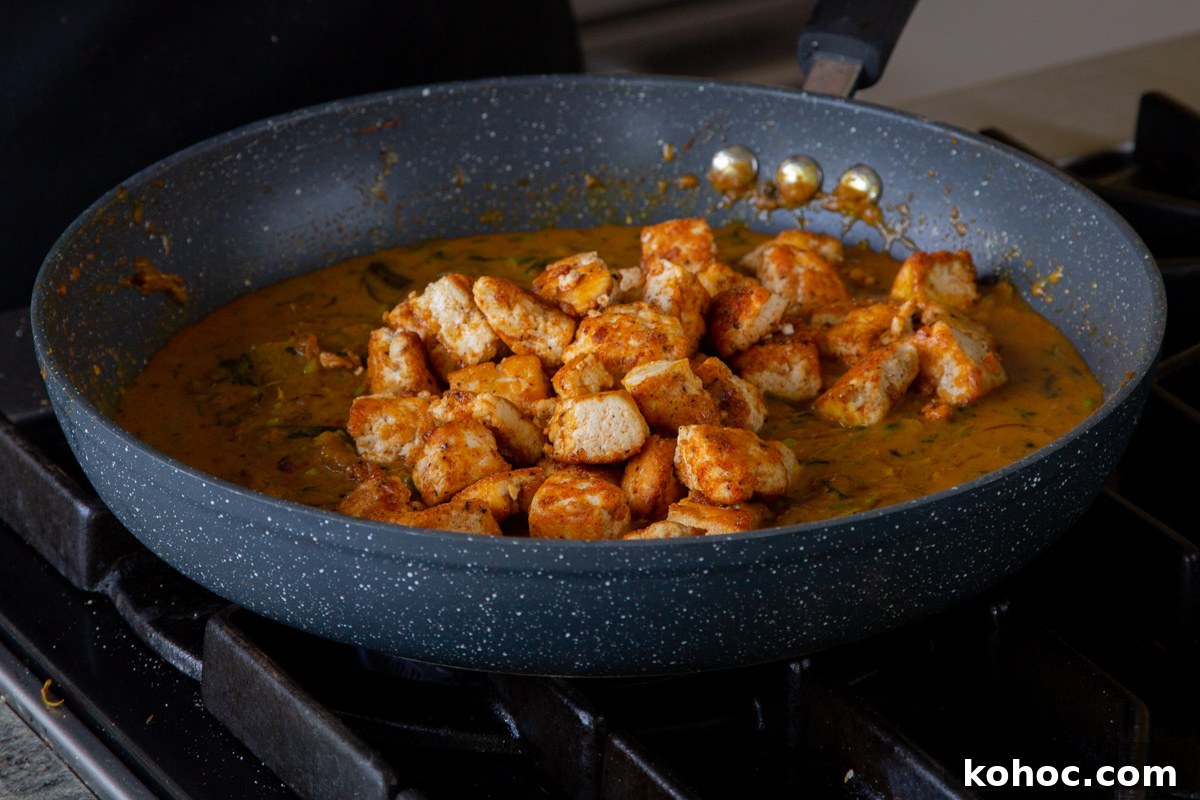 South Indian Black Pepper Tofu Curry with Caramelized Onions 15 adding tofu back to the pan of sauce