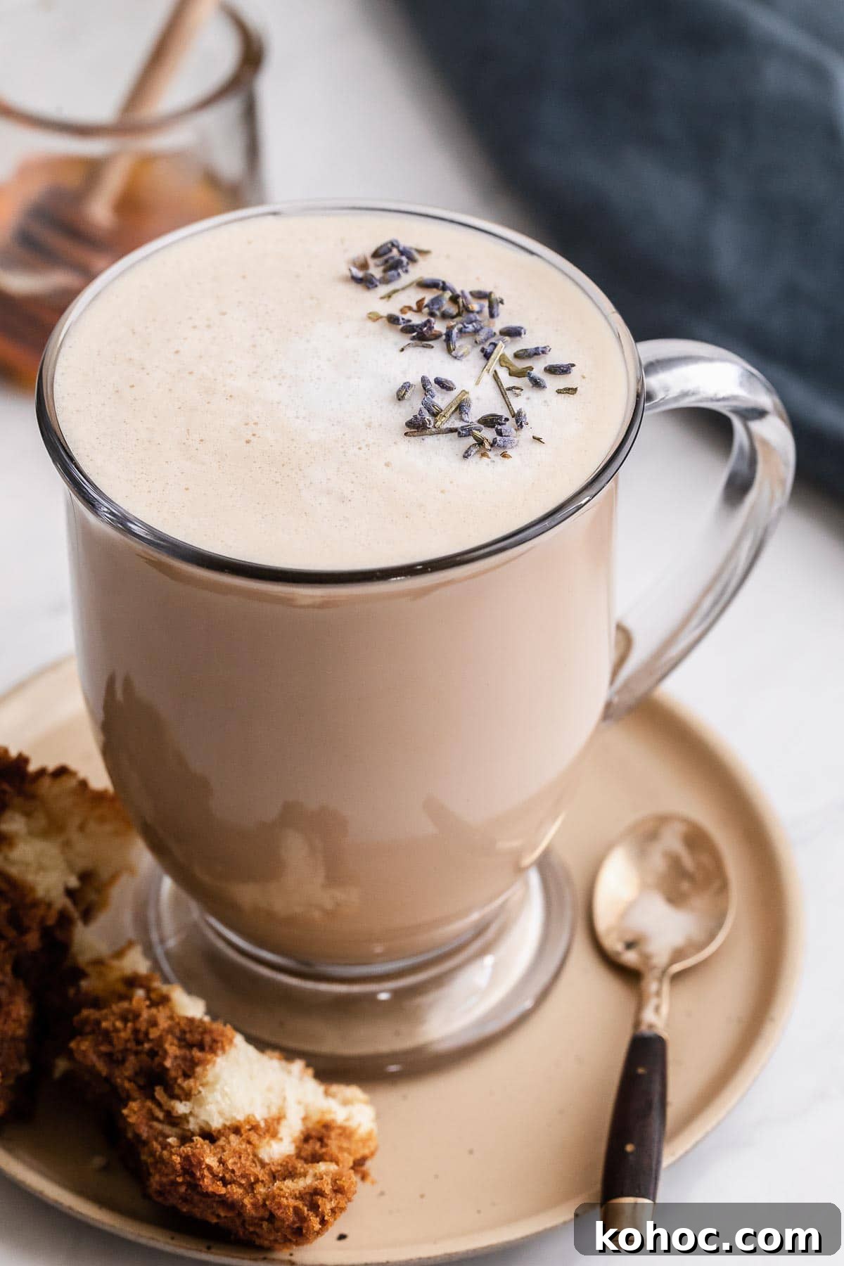 Starbucks London Fog Latte Copycat Recipe: How to Make It at Home 2 London Fog drink in a clear glass mug with lavender buds on top.