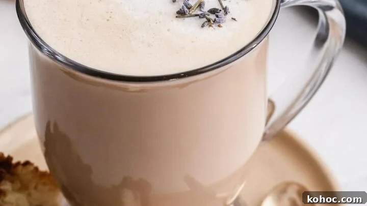 London Fog drink in a clear glass mug with lavender buds on top.