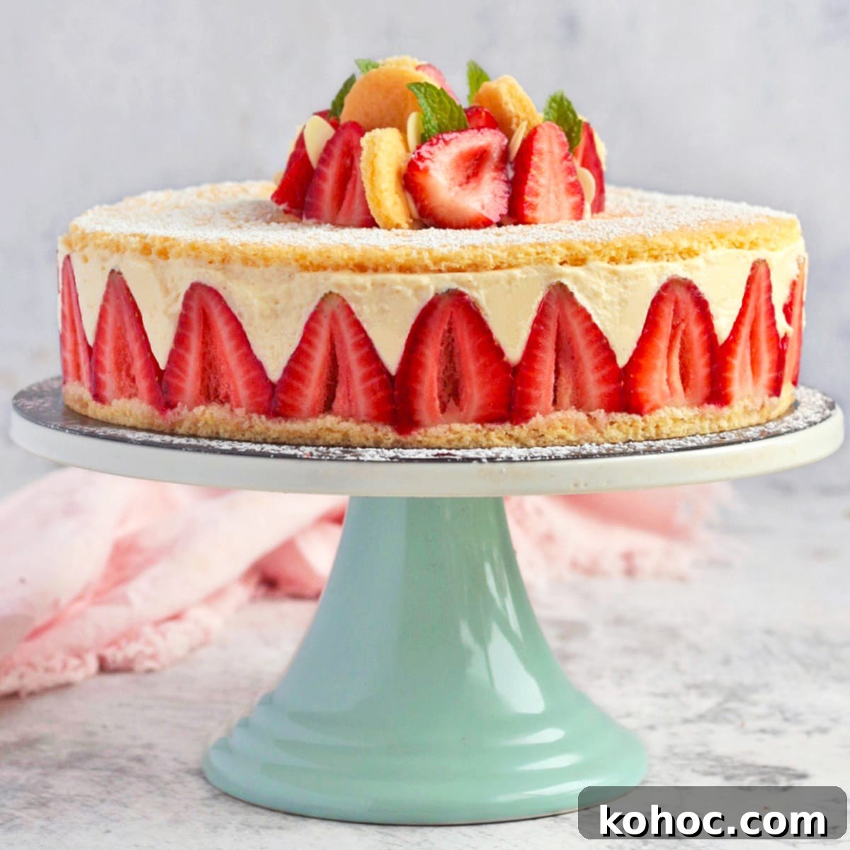 Strawberry Fraisier Cake with Silky Diplomat Cream Filling 2 Fraisier Cake on a Green Cake Stand.