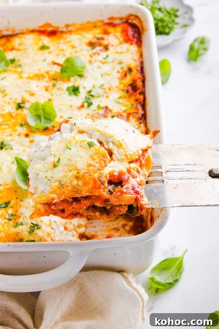 High-Protein Lazy Lasagna Recipe for Quick Meals 13 A slice of high protein lasagna being lifted out of a white baking dish with a spatula