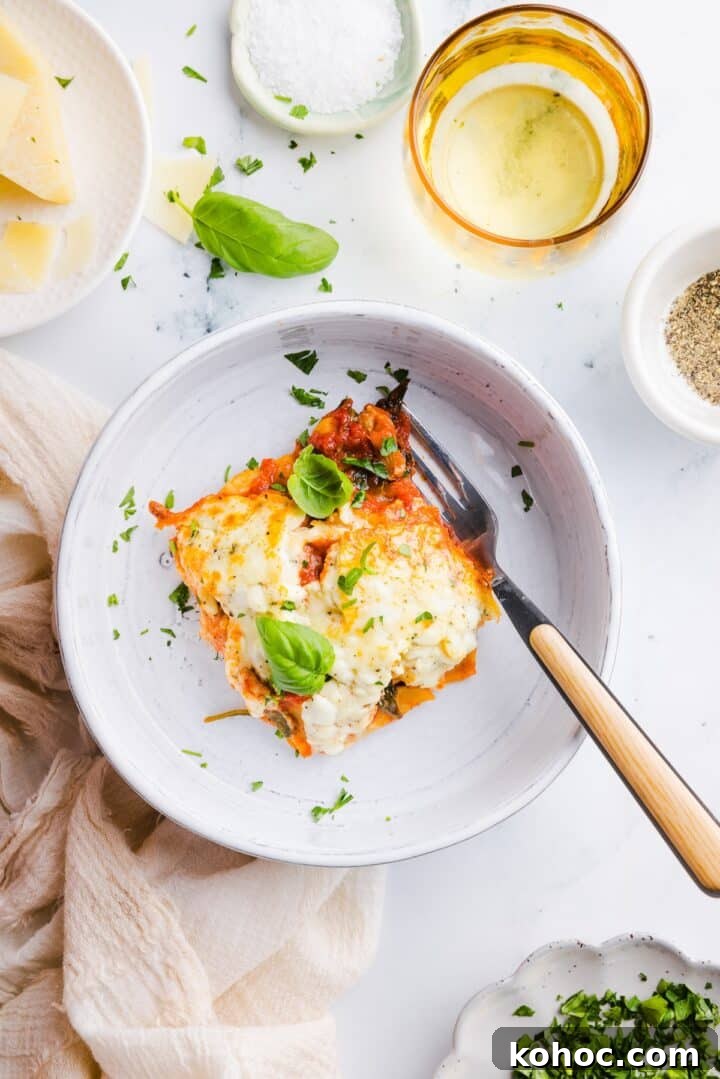 High-Protein Lazy Lasagna Recipe for Quick Meals 3 A slice of high-protein lasagna in a white bowl with a fork
