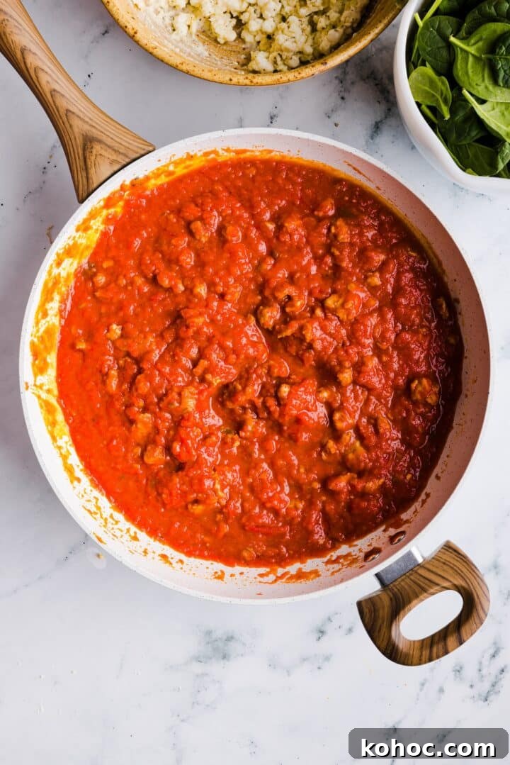 High-Protein Lazy Lasagna Recipe for Quick Meals 7 Tomato meat sauce simmering in a large white pot