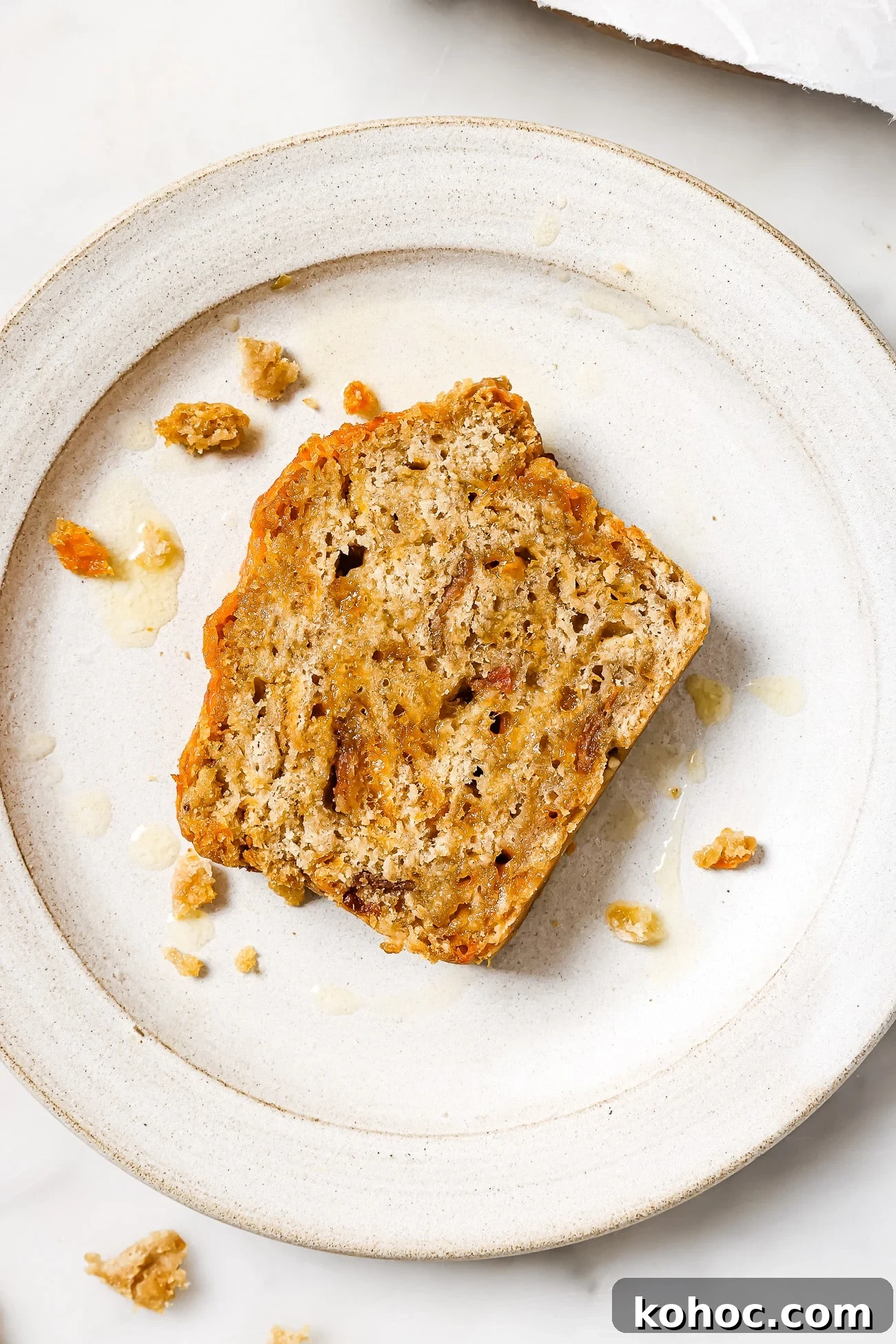 A slice of beer bread on a white plate. 