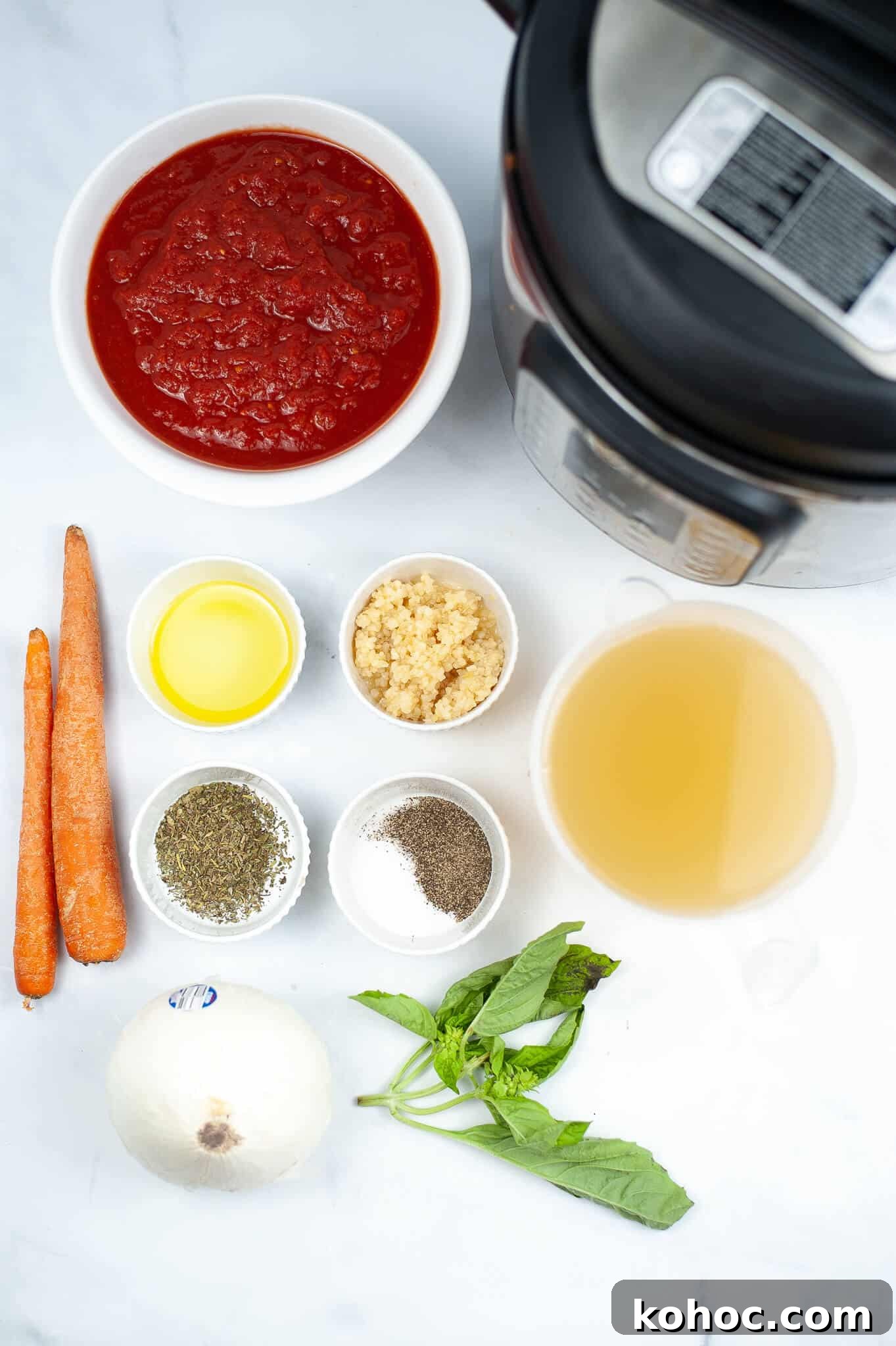 Creamy Instant Pot Tomato Soup Recipe for Quick Weeknight Meals 4 Ingredients for a delicious Instant Pot Tomato Soup are arranged neatly: canned tomatoes, carrots, olive oil, minced garlic, broth, herbs, spices, onion, and fresh basil.