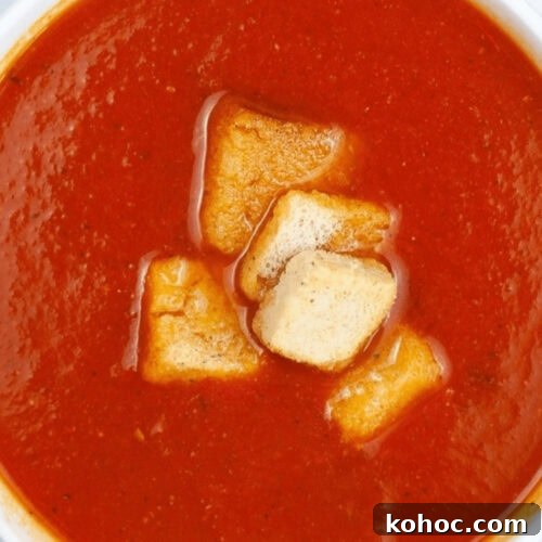 Instant Pot Tomato Soup garnished with crunchy croutons.