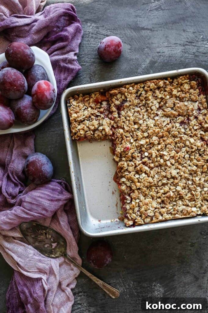 Gluten-Free Plum Cake Recipe: Moist Plum Cake from Scratch 2 a nine inch baking pan with gluten free plum cake with a bowl of fresh plums