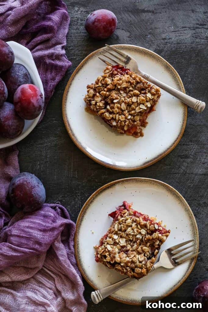 Gluten-Free Plum Cake Recipe: Moist Plum Cake from Scratch 3 Two plates of gluten free plum cake with a bowl of fresh plums
