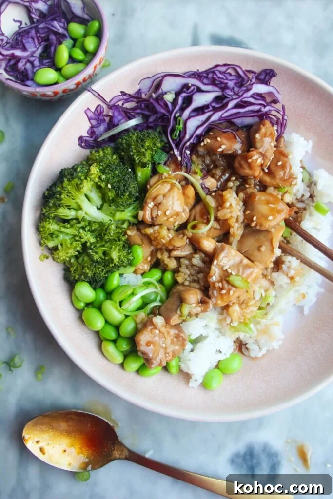 Juicy Chicken Poke Bowl Recipe for Fresh, Flavor-Packed Meals 13 Glossy chicken teriyaki on top of rice with red cabbage, edamame and broccoli.