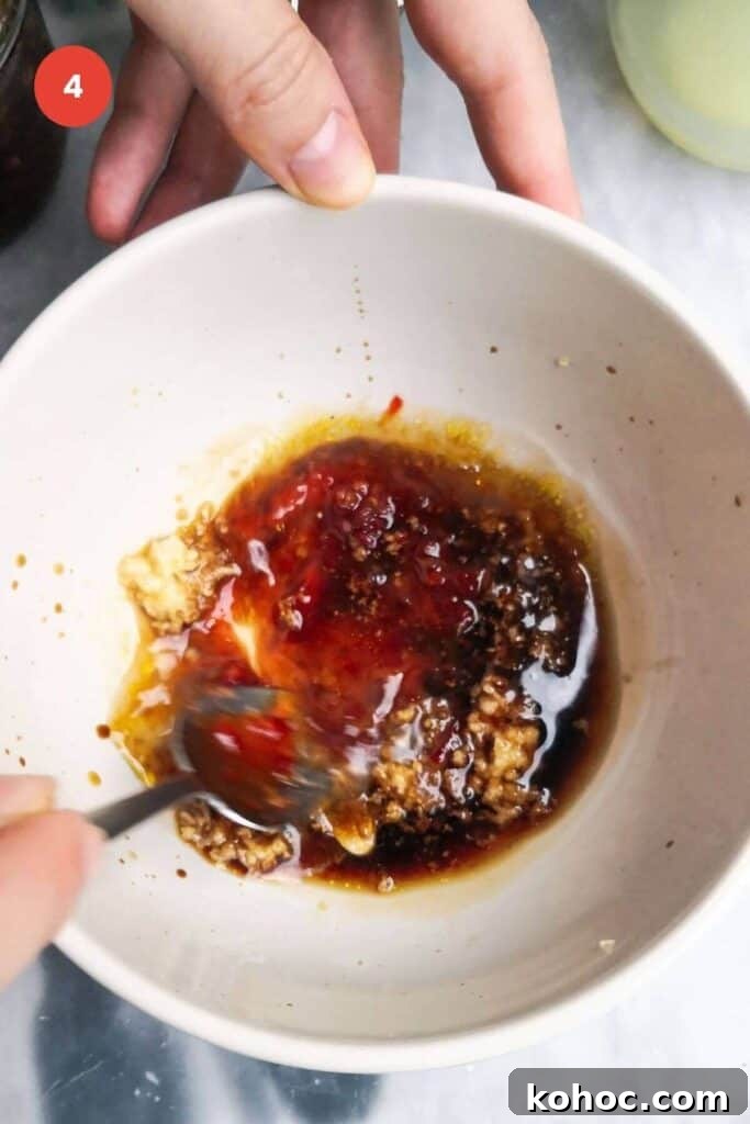 Juicy Chicken Poke Bowl Recipe for Fresh, Flavor-Packed Meals 7 Mixing miso dressing in a bowl.