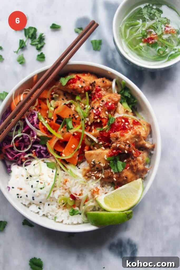 Juicy Chicken Poke Bowl Recipe for Fresh, Flavor-Packed Meals 9 Chicken poke bowl with chopsticks and lime wedge on the side.