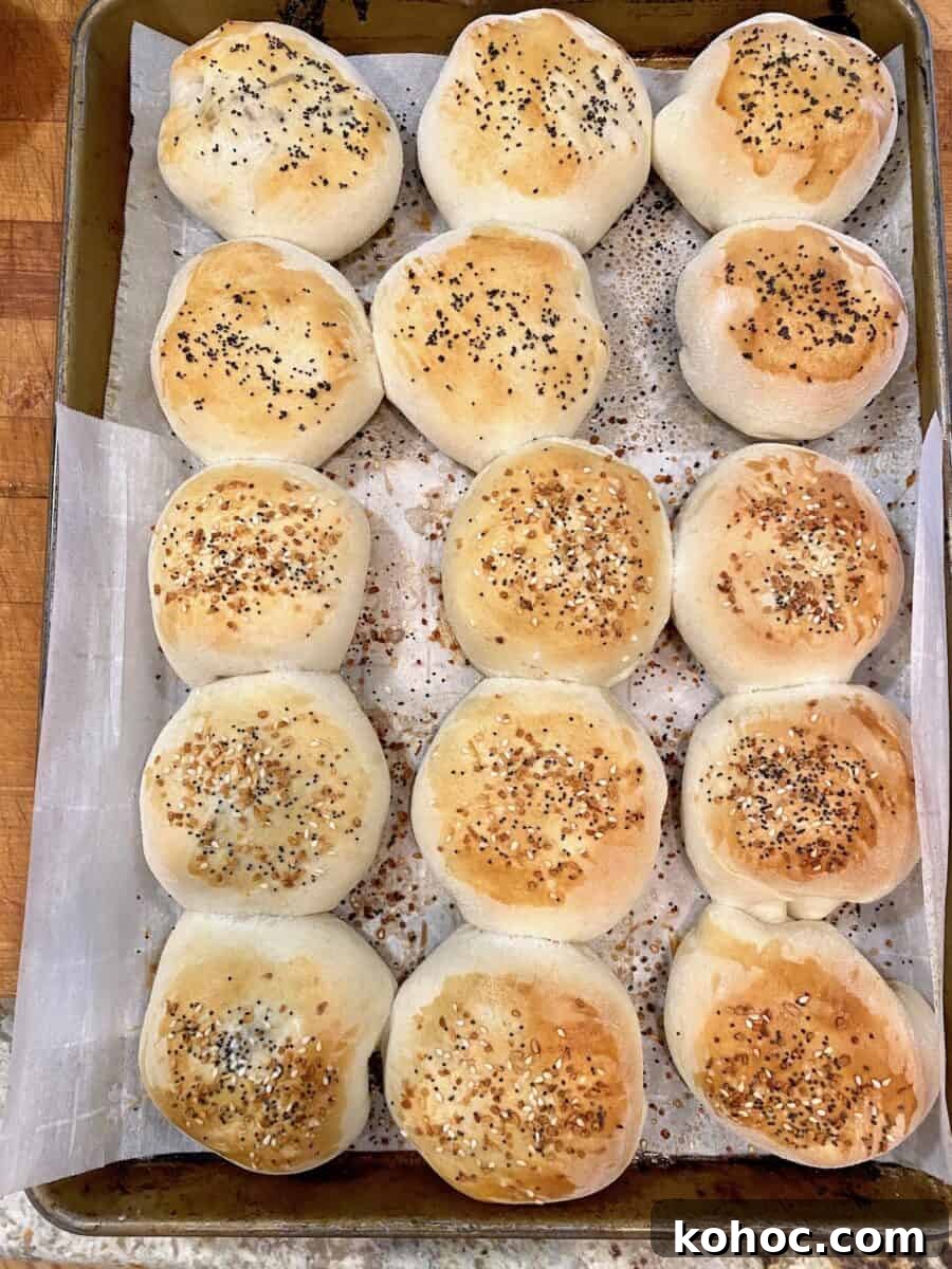 A large cookie sheet with rows of baked, grown up pigs in a blanket