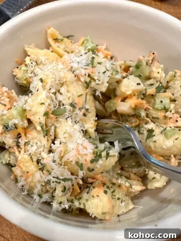 Pasta salad with Italian dressing in a bowl with a fork.