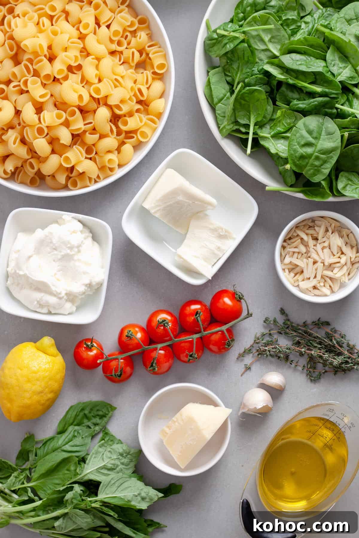 Creamy Baked Ricotta Pesto Pasta with Golden Parmesan Crust 3 Ingredients for ricotta pesto pasta on a gray table.