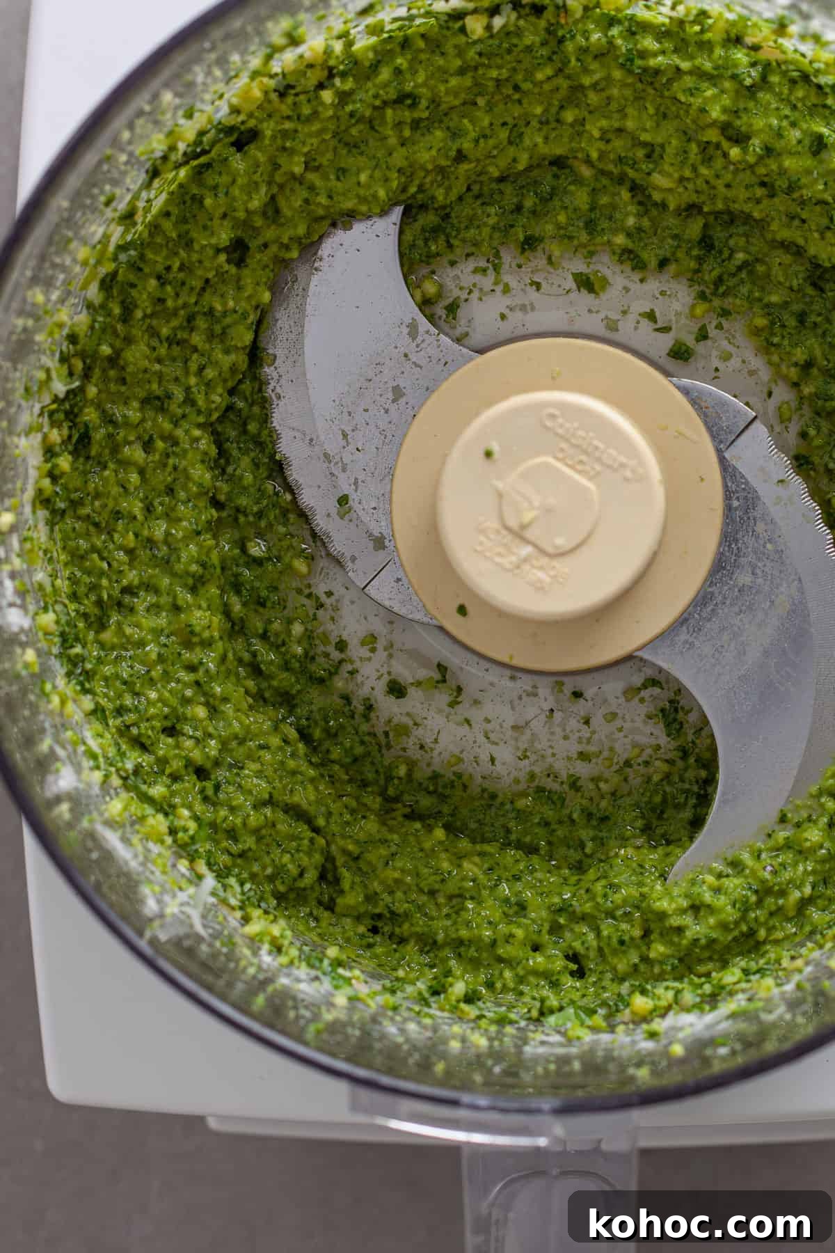 Creamy Baked Ricotta Pesto Pasta with Golden Parmesan Crust 4 A close up of pesto sauce blended in a food processor.