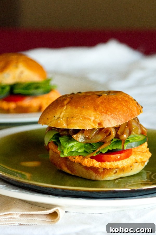 Roasted Red Pepper Hummus Sandwich Recipe for Flavorful Lunch 6 two sandwiches on buns on a table with a white cloth.