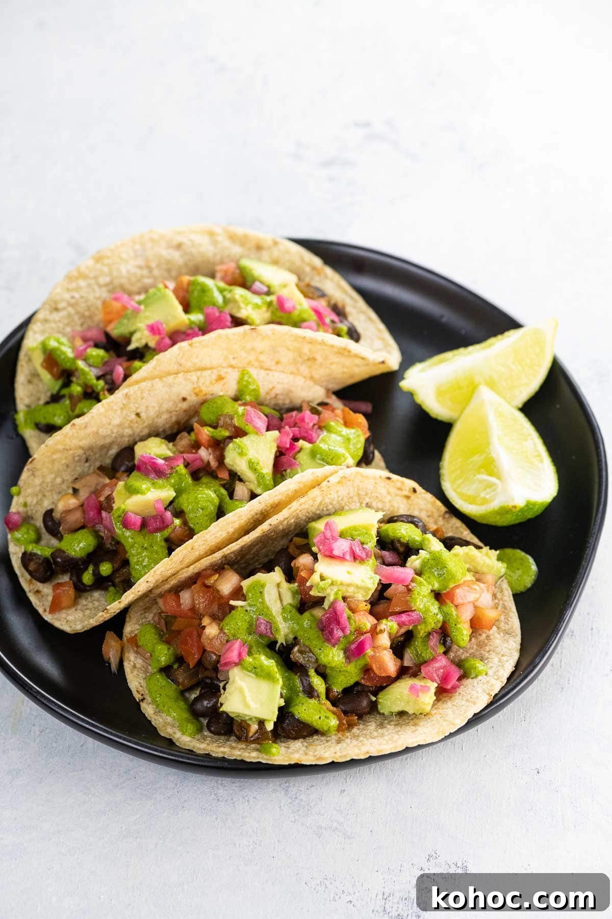 Flavorful Black Bean Vegan Tacos with Avocado Salsa 6 black bean vegan tacos on a plate