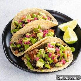 Flavorful Black Bean Vegan Tacos with Avocado Salsa 7 black bean vegan tacos on a plate