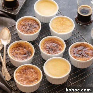 Vanilla bean creme brulee in white ramekins on a wire rack.
