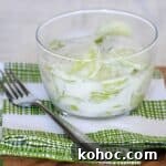 cucumber salad with creamy dressing in glass bowl