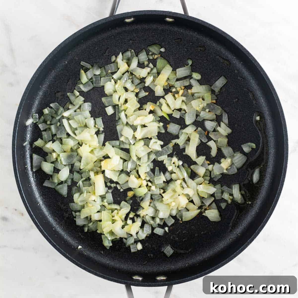 Sautéed onion and garlic in a skillet.