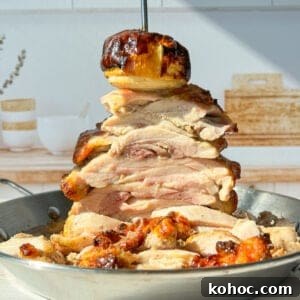 30 High-Protein Dinner Recipes for Muscle & Weight Goals 10 A towering stack of sliced roasted chicken on a skewer.
