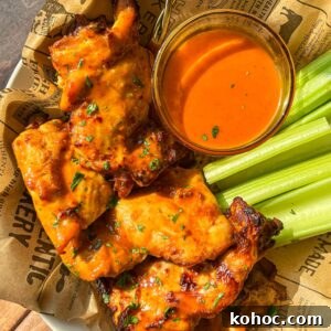 30 High-Protein Dinner Recipes for Muscle & Weight Goals 12 Saucy grilled chicken wings with celery sticks.