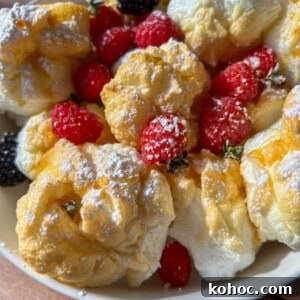 30 High-Protein Dinner Recipes for Muscle & Weight Goals 5 A bowl of fluffy cream puffs dusted with powdered sugar, with fresh raspberries.