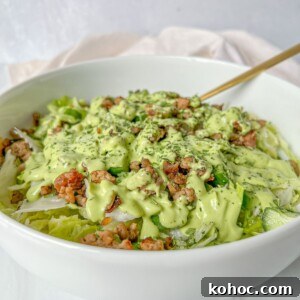 30 High-Protein Dinner Recipes for Muscle & Weight Goals 15 A green salad topped with crumbled meat and creamy dressing.