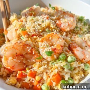 30 High-Protein Dinner Recipes for Muscle & Weight Goals 17 A bowl of shrimp fried rice with veggies and eggs.