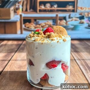 30 High-Protein Dinner Recipes for Muscle & Weight Goals 18 A glass filled with creamy dessert layered with raspberries and crumbs.