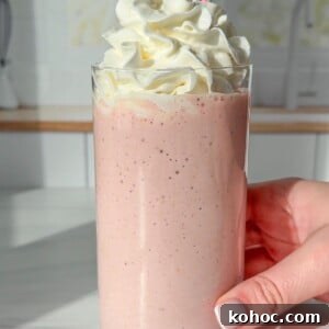 30 High-Protein Dinner Recipes for Muscle & Weight Goals 19 A pink strawberry protein shake topped with whipped cream.