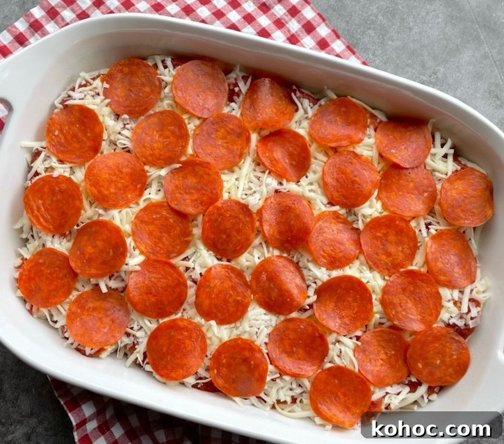 Bubble-Up Biscuit Pizza Casserole Recipe for Family Nights 8 A yummy pizza casserole ready for the oven! This easy meal is topped with lots of pepperoni and cheese, making for a delicious family meal on busy school nights.