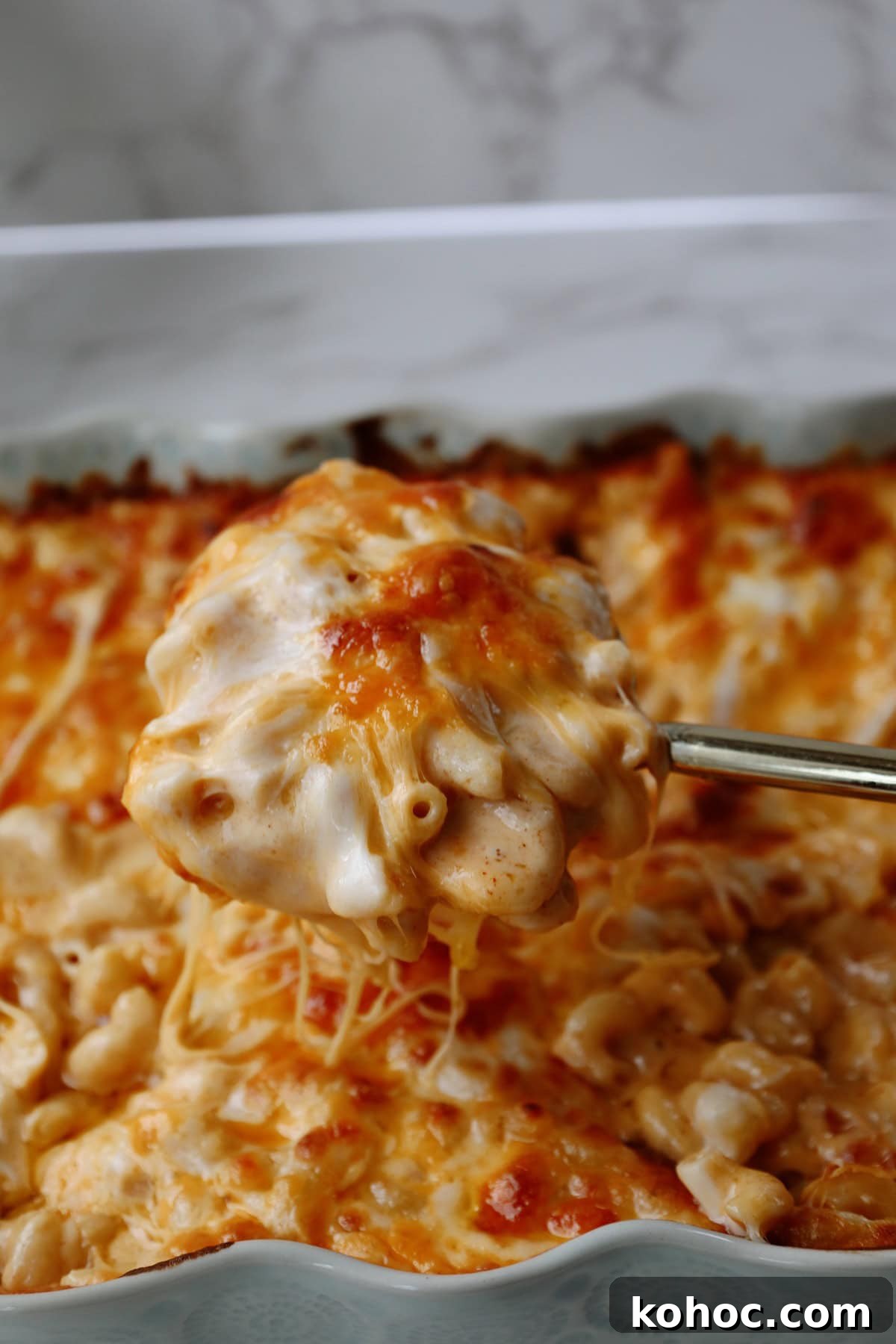 Ultimate Extra-Cheesy Mac and Cheese Recipe for Comfort Meals 2 Extra cheesy mac and cheese being scooped from a pan.