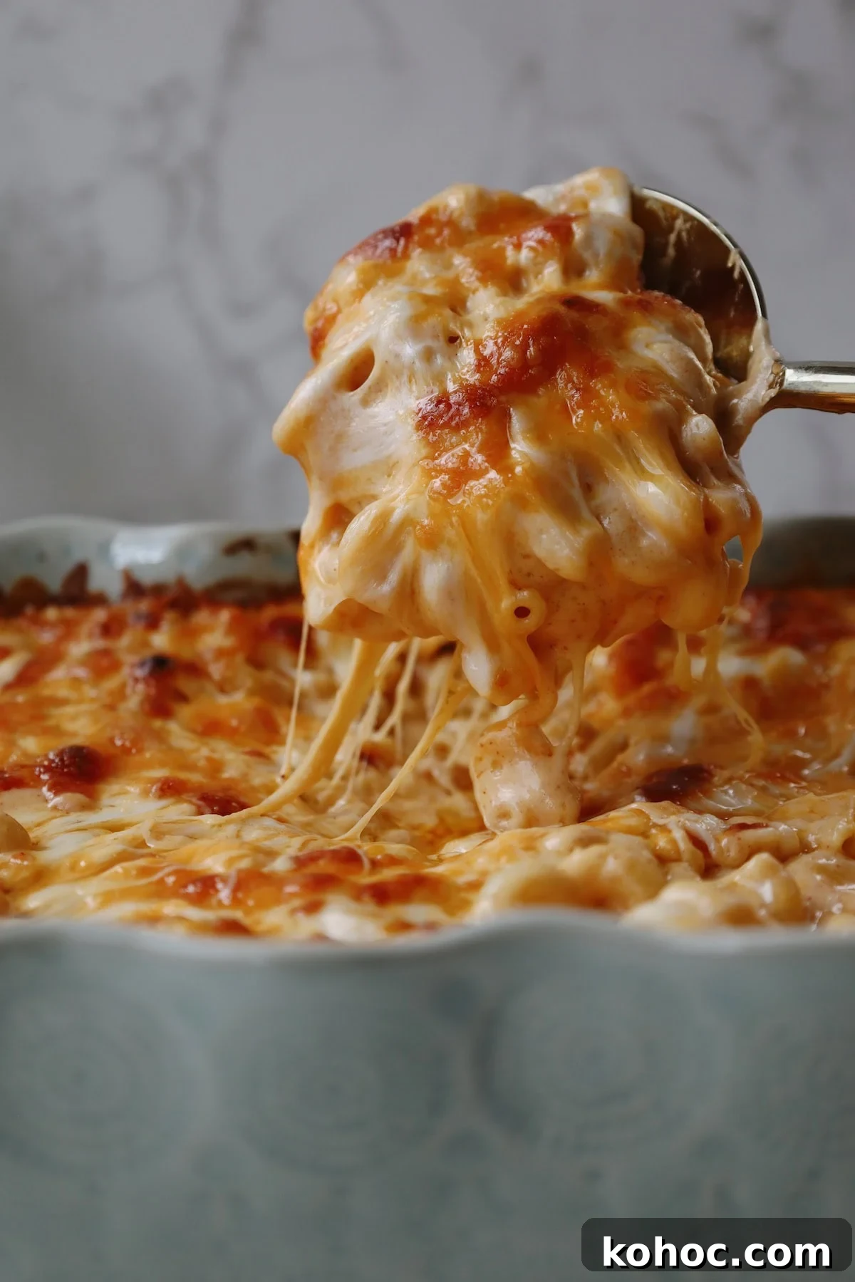 Ultimate Extra-Cheesy Mac and Cheese Recipe for Comfort Meals 12 Melted cheese on top of macaroni noodles.