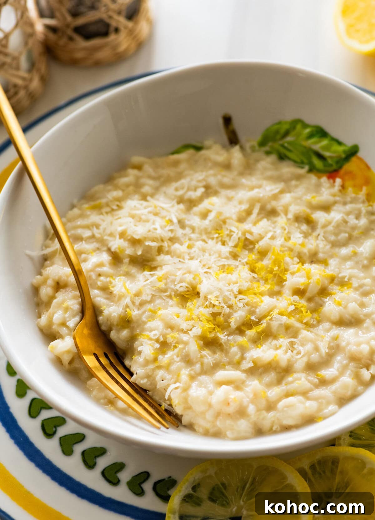 Creamy Lemon Risotto with Parmesan and Fresh Herbs 13 A bowl of lemon risotto with a fork resting in it.