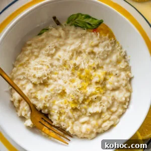 Creamy Lemon Risotto with Parmesan and Fresh Herbs 15 A bowl of lemon risotto with a fork resting in it.