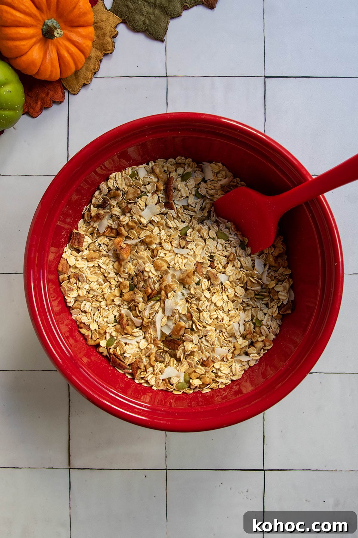 Pumpkin Granola with Maple or Date Syrup 5 Red bowl of drying ingredients mixed together.