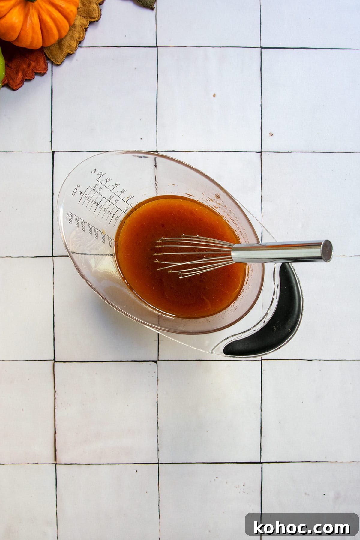 Pumpkin Granola with Maple or Date Syrup 6 Olive oil, maple syrup and honey in measuring cup with a whisk.