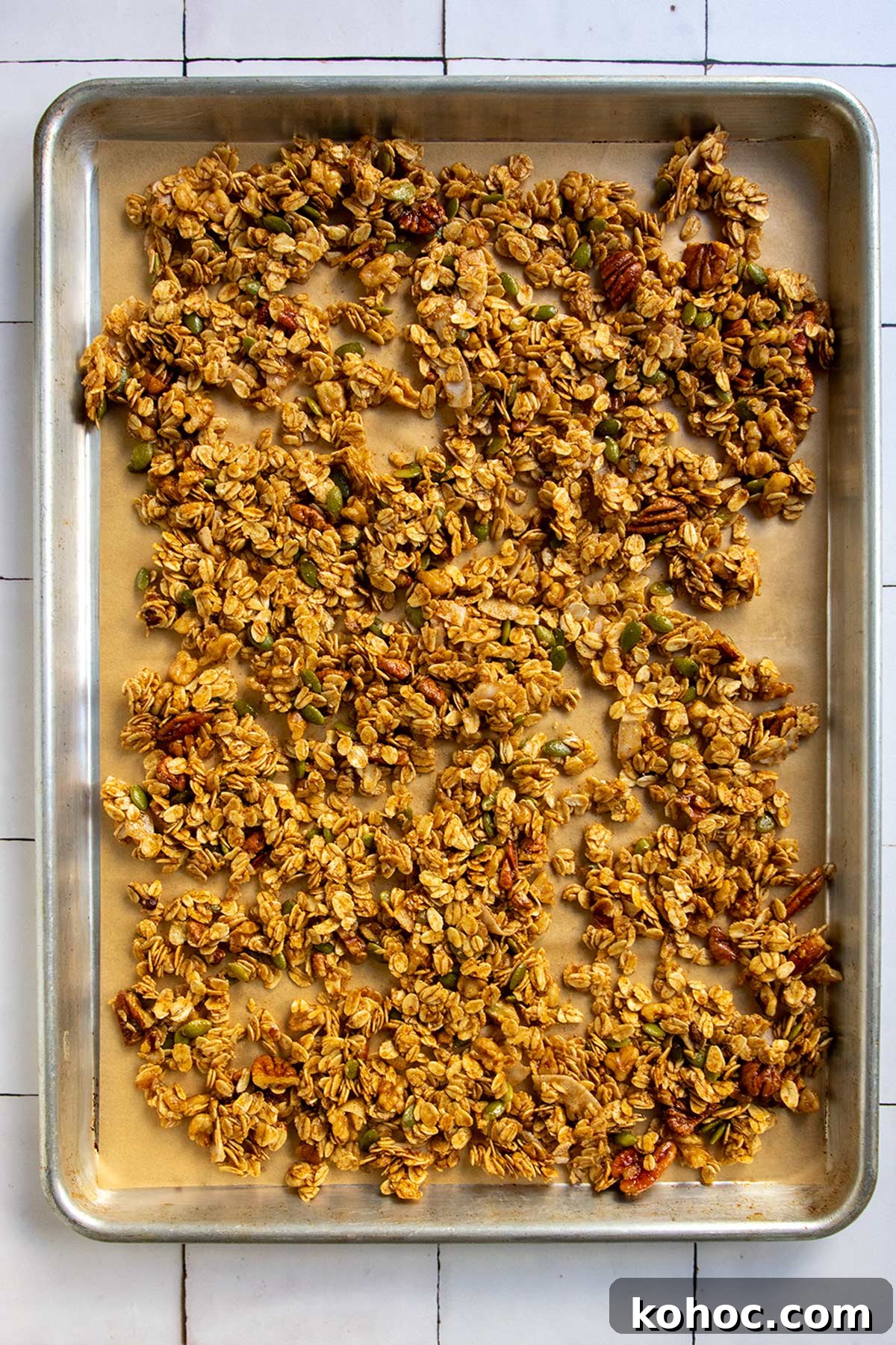 Pumpkin Granola with Maple or Date Syrup 9 Unbaked granola on parchment-lined sheet tray, ready for the oven.