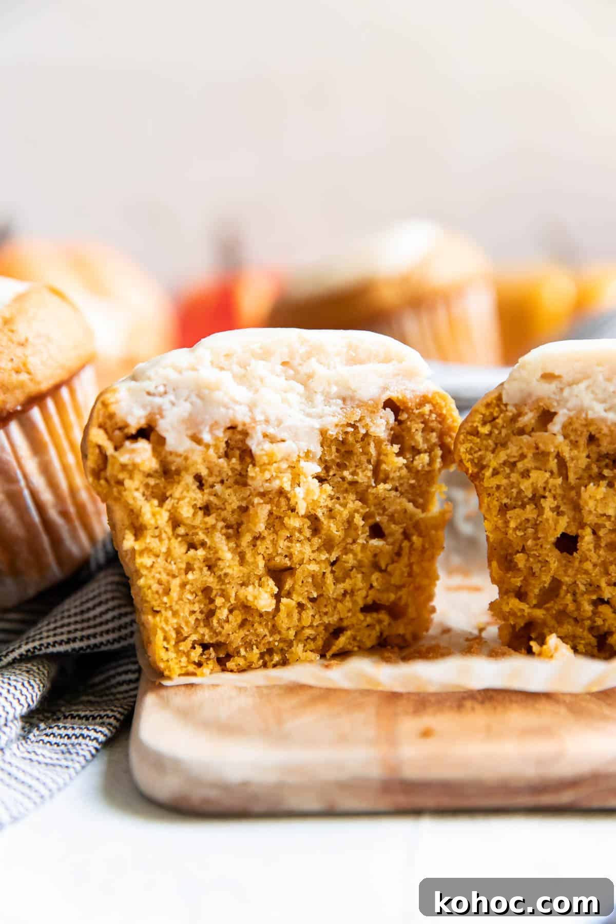 Moist Pumpkin Muffins with Cream Cheese Swirl 3 pumpkin cream cheese muffins cut open.