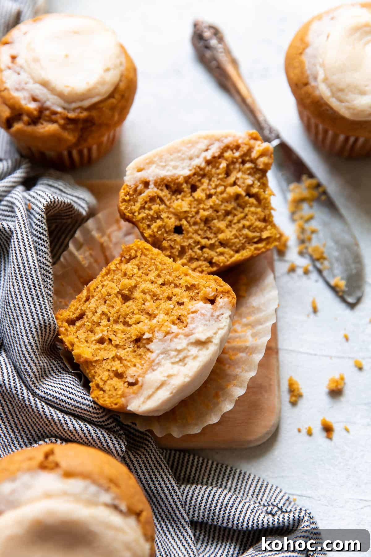 Moist Pumpkin Muffins with Cream Cheese Swirl 9 pumpkin cream cheese muffins cut open.