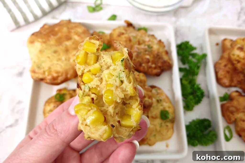 holding up a split in half corn fritter