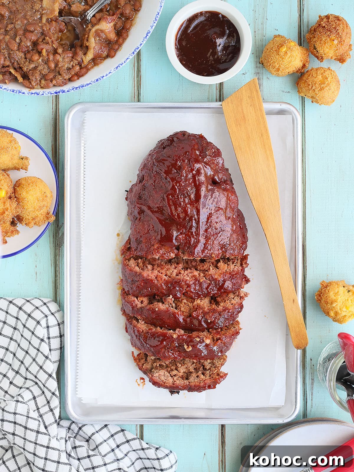 Smoked Meatloaf Recipe for Pellet Grills: Juicy, Flavorful Slice 2 Sliced meatloaf on a parchment paper-lined tray.