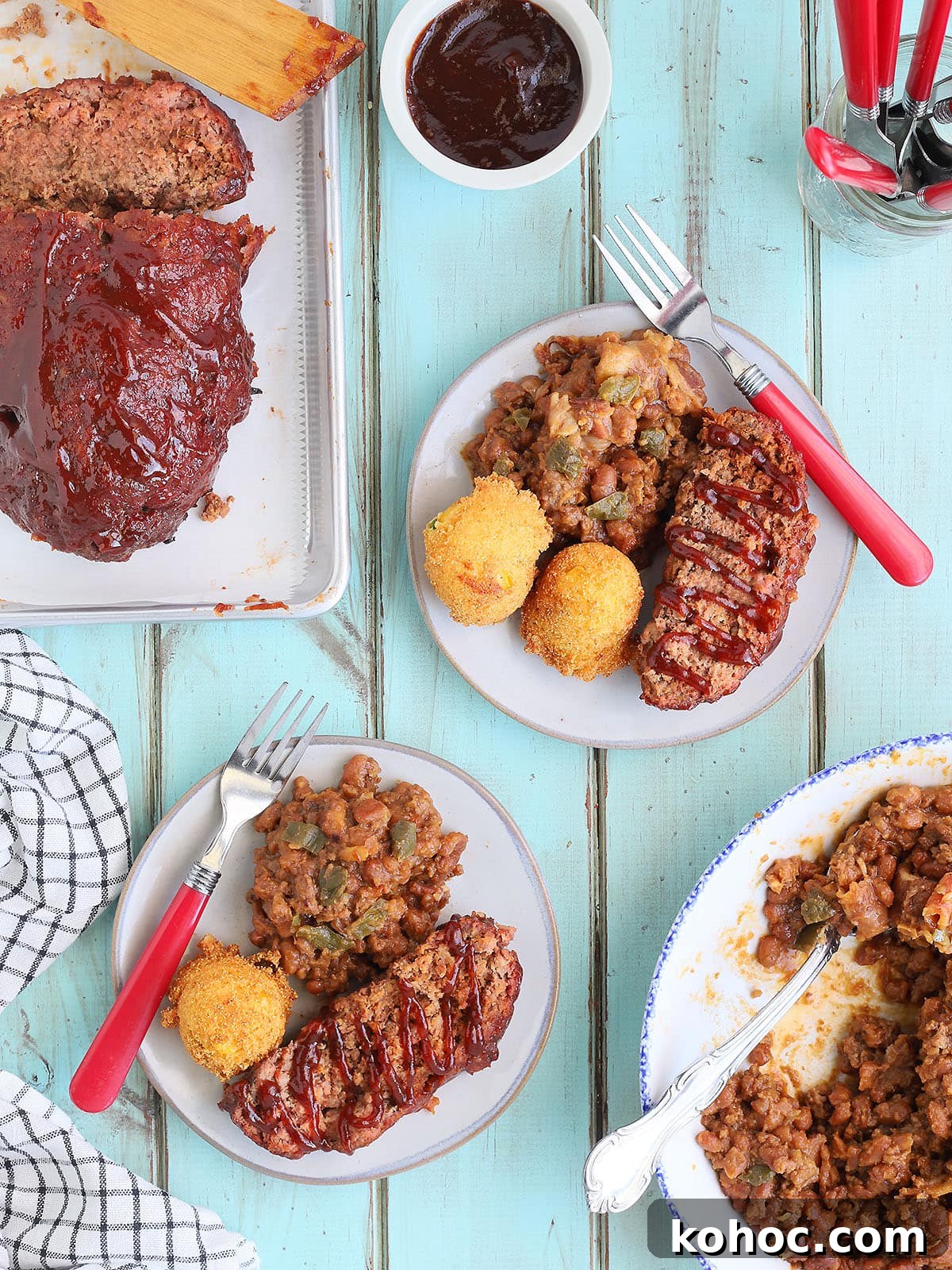 Smoked Meatloaf Recipe for Pellet Grills: Juicy, Flavorful Slice 15 Sliced of meatloaf garnished with barbecue sauce with a side of baked beans and fried hush puppies.