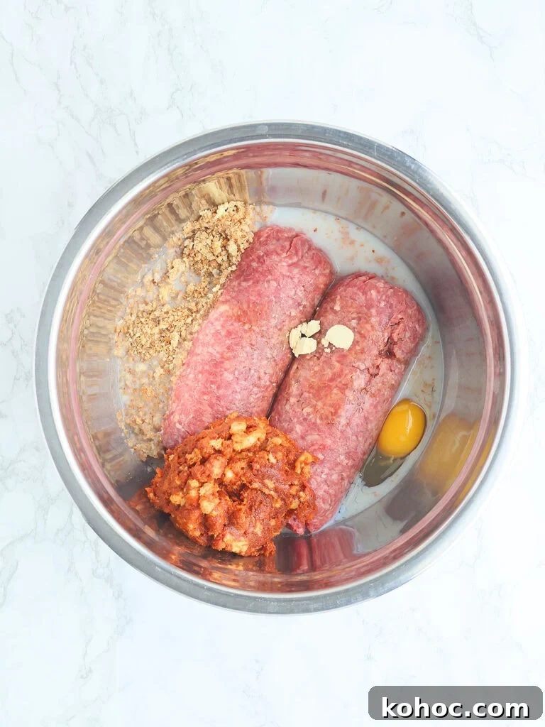 Smoked Meatloaf Recipe for Pellet Grills: Juicy, Flavorful Slice 7 Meatloaf ingredients unmixed in a metal mixing bowl.